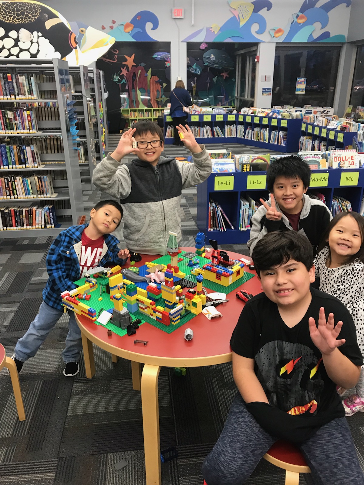 A group of children building with Legos