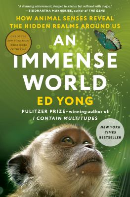 Book cover of "An Immense World", featuring a monkey's face.