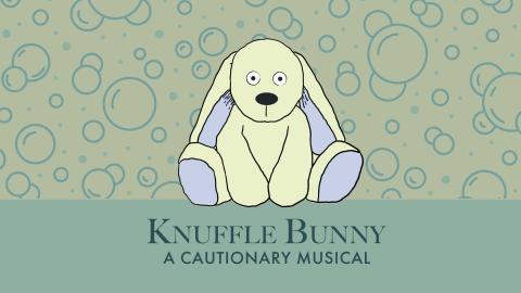 Large stuffed bunny with text that reads "Knuffle Bunny: A Cautionary Musical"